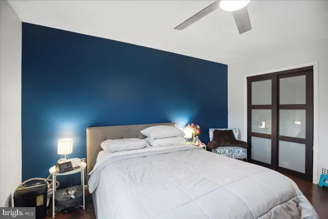 a bedroom with bed and flat tv screen on dresser