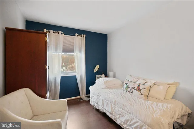 a bedroom with a bed and a large window