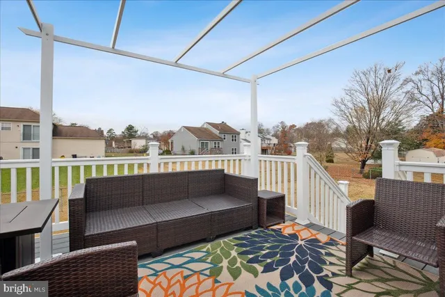a balcony with furniture and a rug