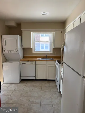a kitchen with a stove a refrigerator and a sink