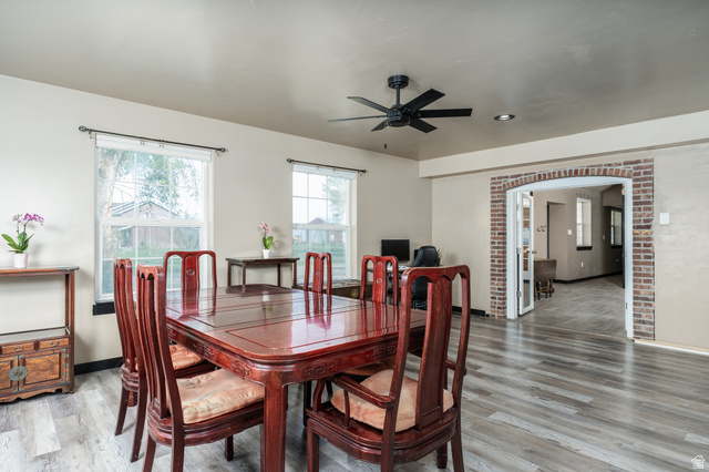 19994 South Olson Road Downey, ID 83234 - Photo 6 of 49 Dining area featuring light wood-style flooring, a ceiling fan, and arched walkways