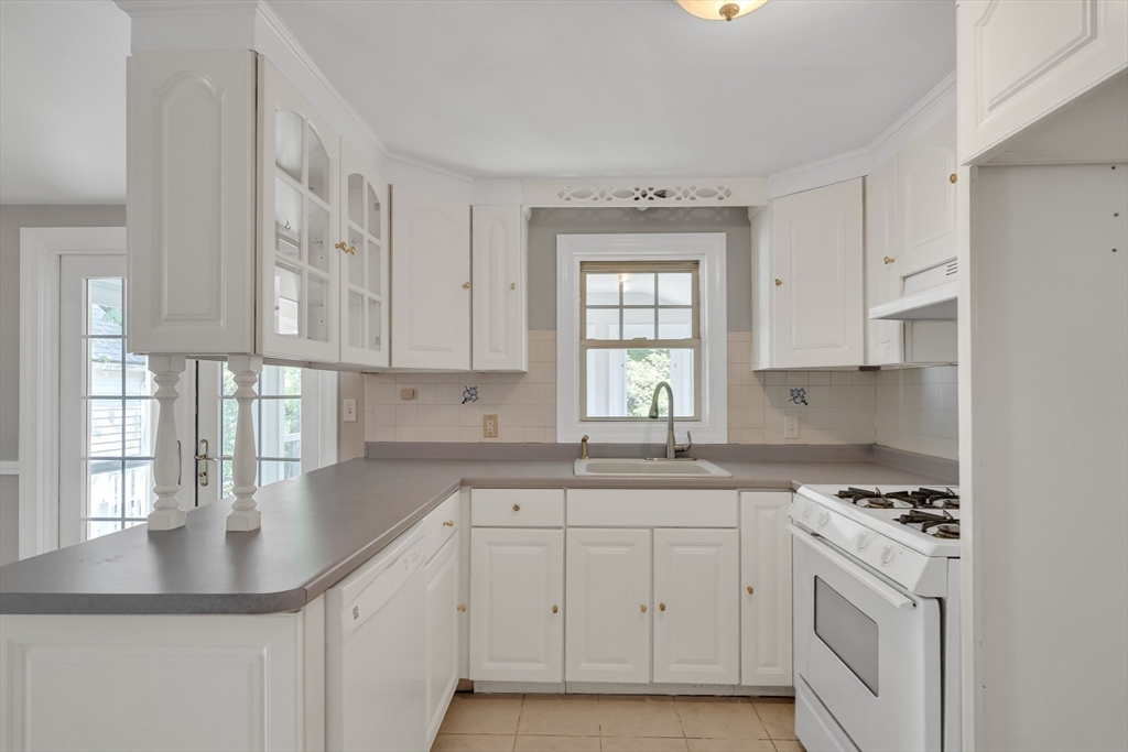 17 Beech Circle Andover, MA 01810 - Photo 11 of 36 a kitchen with cabinets appliances a sink and a window
