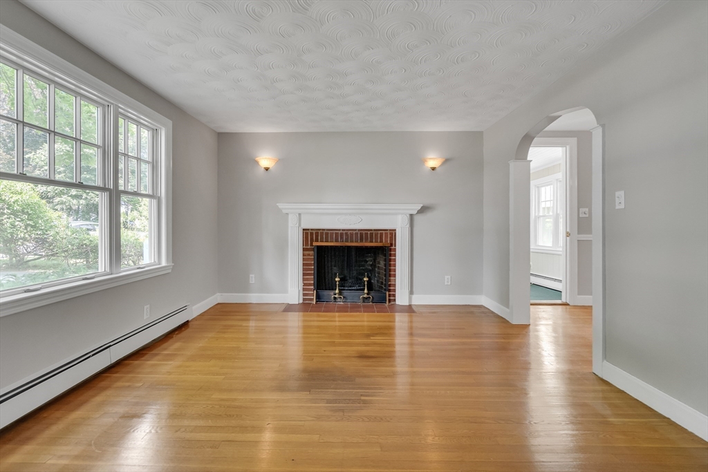 17 Beech Circle Andover, MA 01810 - Photo 16 of 36 a view of an empty room with a window and wooden floor