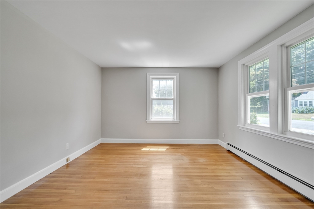 17 Beech Circle Andover, MA 01810 - Photo 19 of 36 an empty room with wooden floor and windows