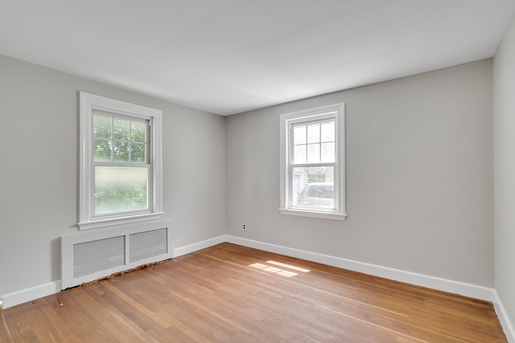 17 Beech Circle Andover, MA 01810 - Photo 21 of 36 an empty room with wooden floor and windows