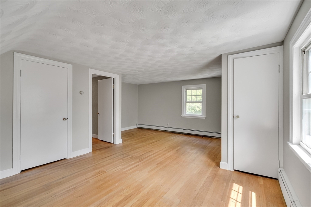17 Beech Circle Andover, MA 01810 - Photo 26 of 36 an empty room with wooden floor and windows