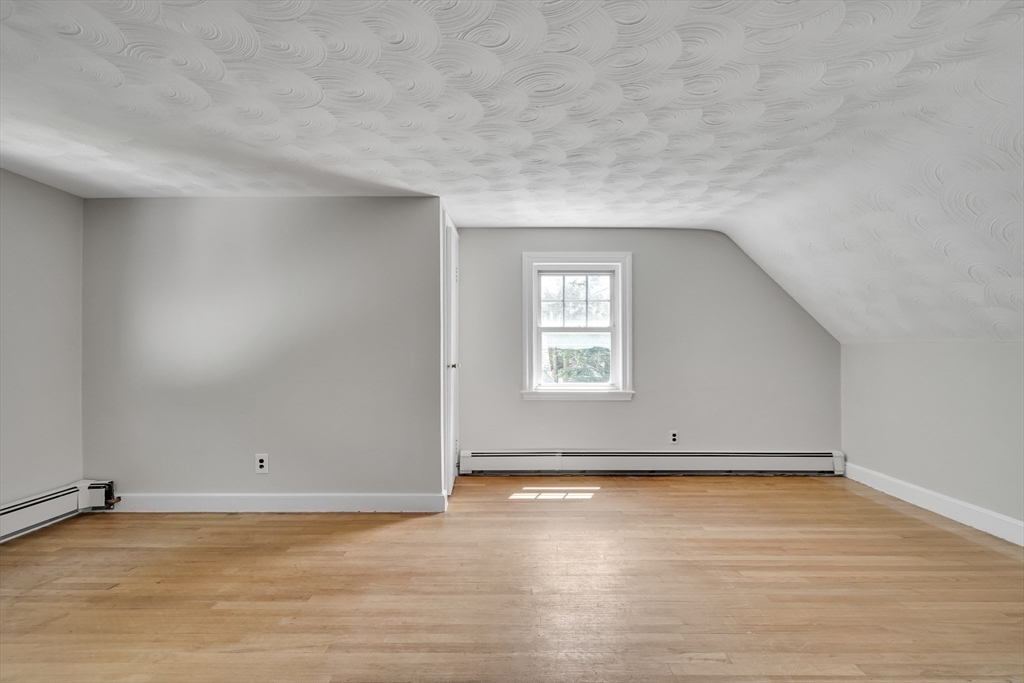 17 Beech Circle Andover, MA 01810 - Photo 28 of 36 an empty room with wooden floor and windows