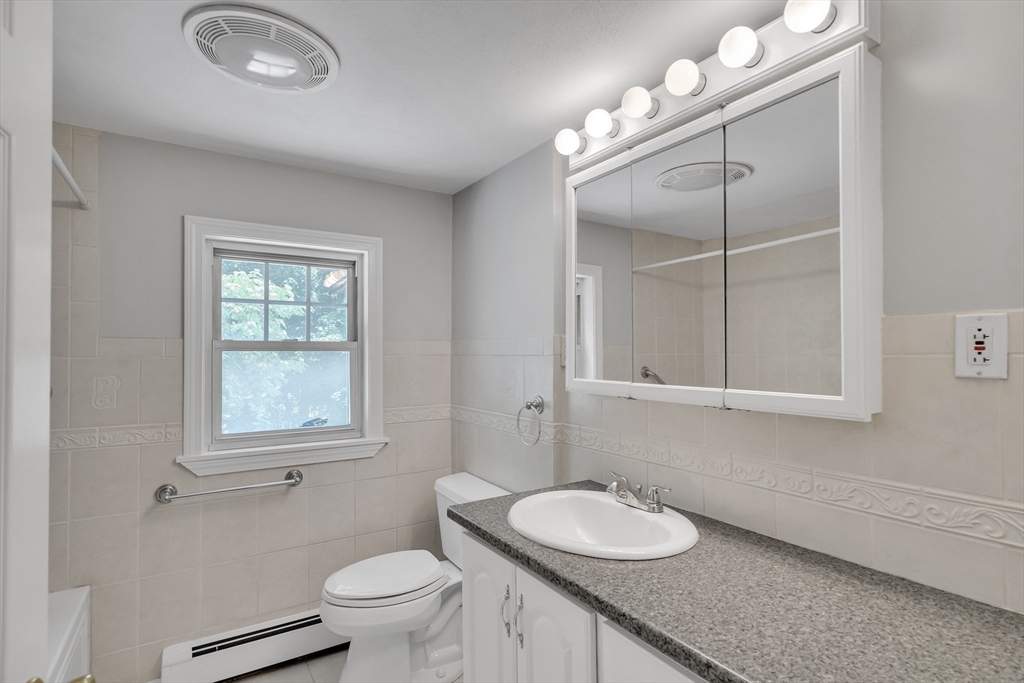 17 Beech Circle Andover, MA 01810 - Photo 31 of 36 a bathroom with a granite countertop sink a toilet and a mirror