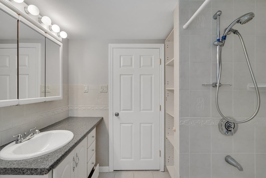 17 Beech Circle Andover, MA 01810 - Photo 33 of 36 a bathroom with a granite countertop sink a mirror and a shower