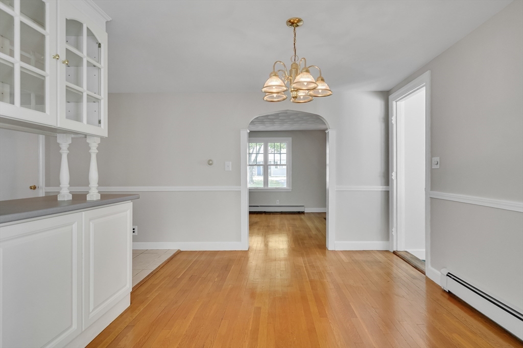 17 Beech Circle Andover, MA 01810 - Photo 10 of 36 a view of a room with wooden floor and chandelier