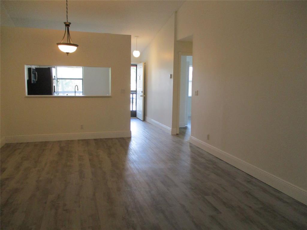 22040 Palms Way, Unit 205 Boca Raton, FL 33433 - Photo 14 of 19 a view of an empty room with wooden floor and a window