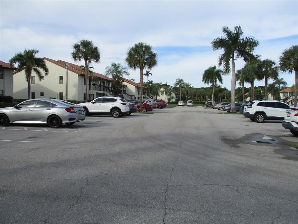 22040 Palms Way, Unit 205 Boca Raton, FL 33433 - Photo 4 of 19 a view of street with parked cars
