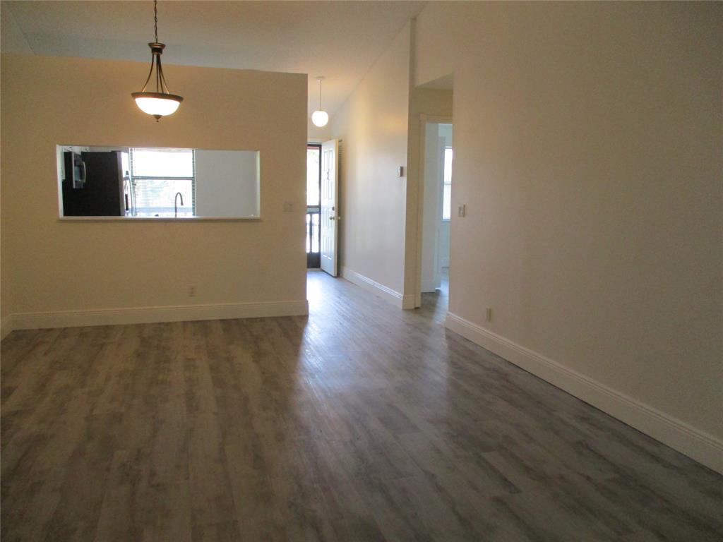 22040 Palms Way, Unit 205 Boca Raton, FL 33433 - Photo 9 of 19 an empty room with wooden floor and windows
