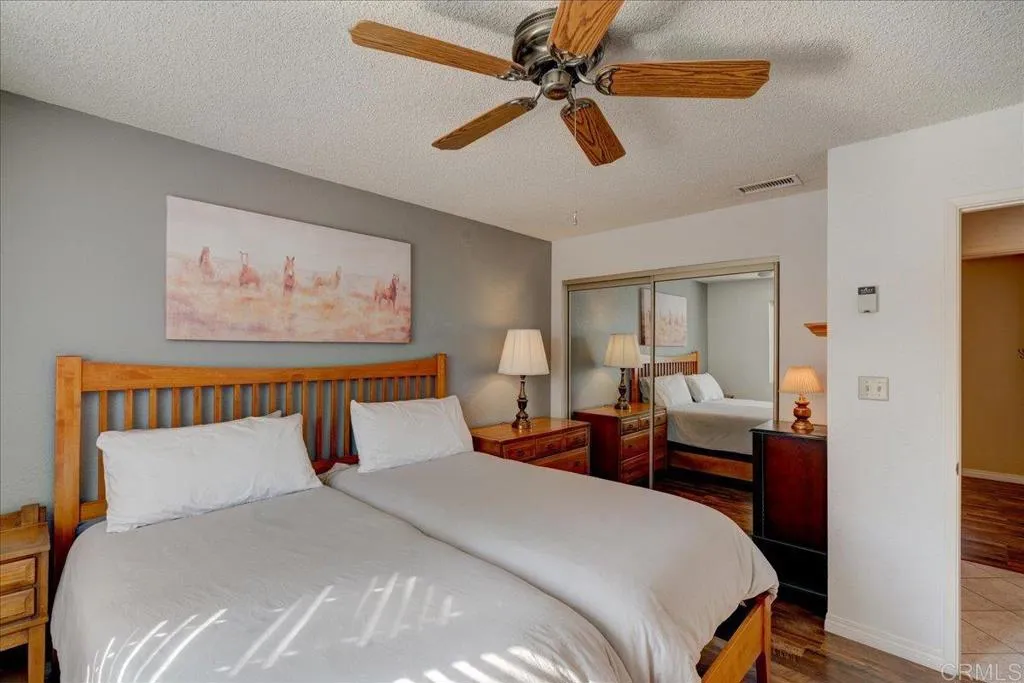 15753 Lyons Valley Road Jamul, CA 91935 - Photo 17 of 47 a bedroom with a bed and a chandelier