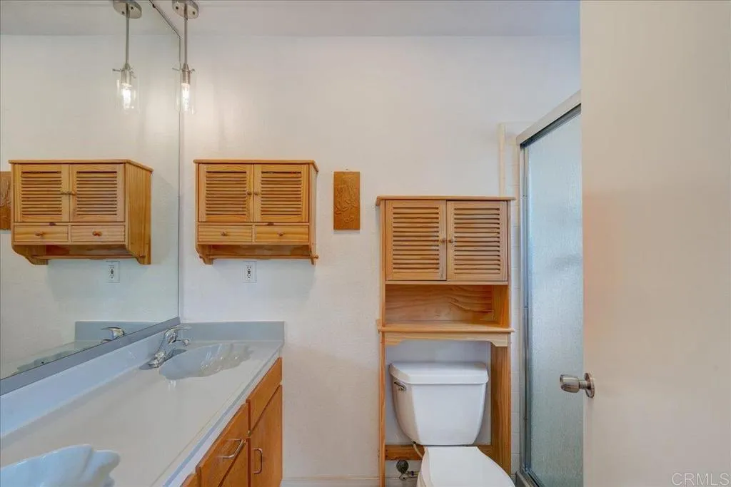 15753 Lyons Valley Road Jamul, CA 91935 - Photo 18 of 47 a bathroom with a granite countertop toilet sink and mirror
