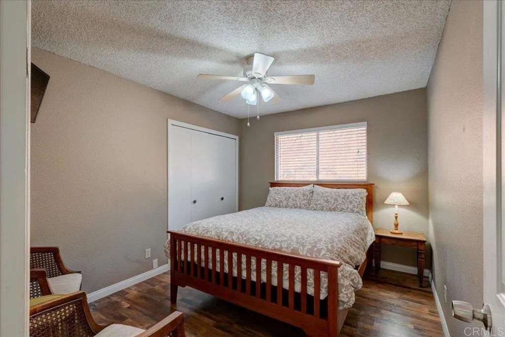 15753 Lyons Valley Road Jamul, CA 91935 - Photo 19 of 47 a bedroom with a bed and a chandelier