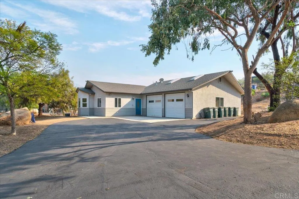 15753 Lyons Valley Road Jamul, CA 91935 - Photo 26 of 47 a front view of a house with a yard and garage