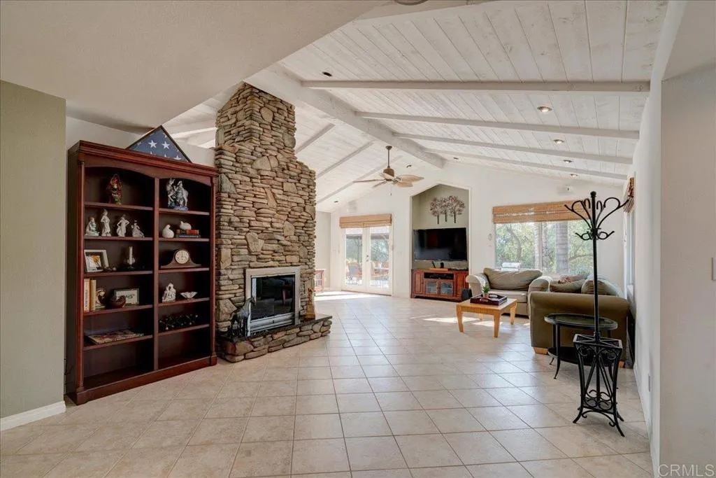 15753 Lyons Valley Road Jamul, CA 91935 - Photo 5 of 47 a living room with furniture a fireplace and a flat screen tv