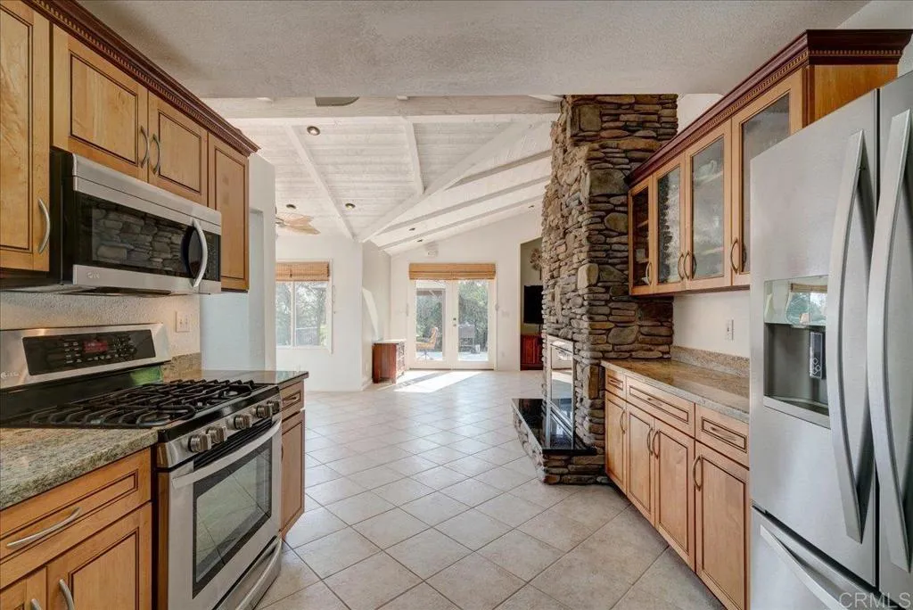15753 Lyons Valley Road Jamul, CA 91935 - Photo 8 of 47 a kitchen with stainless steel appliances a stove a sink and a refrigerator