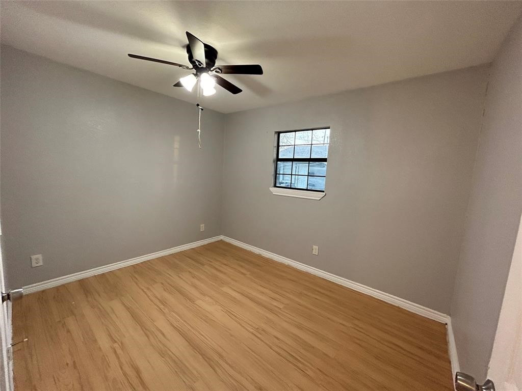 6818 Weston Street, Unit 1 Houston, TX 77021 - Photo 5 of 10 wooden floor in an empty room with a window