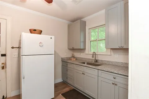 a white refrigerator freezer sitting inside of a kitchen