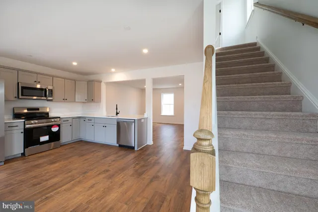 a kitchen with a refrigerator and a sink