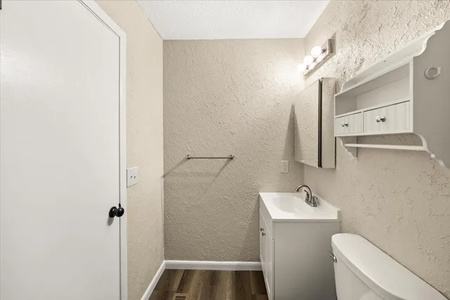 a bathroom with a sink and mirror with toilet