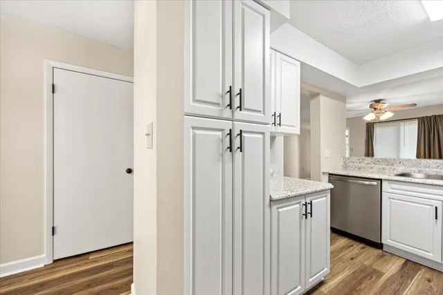a kitchen with stainless steel appliances granite countertop a sink and a refrigerator
