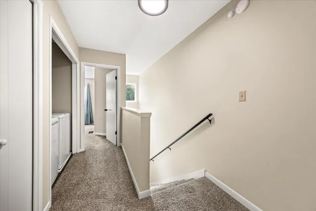 a view of a hallway with wooden floor and entryway