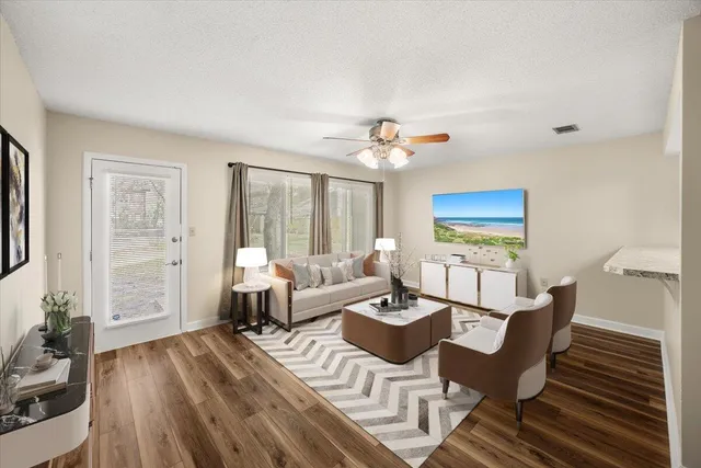 a living room with furniture and wooden floor