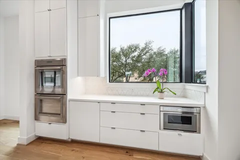 a kitchen with counter top space a sink and appliances
