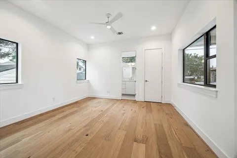a living room with furniture kitchen view and a chandelier