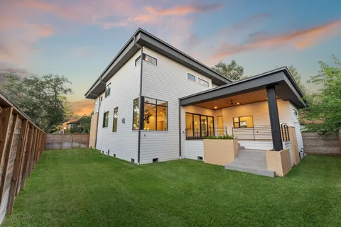 a living room with furniture a fireplace and a large window