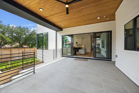 a view of a porch with wooden floor and fence