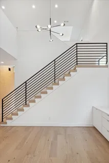 a view of hallway with furniture and wooden floor