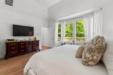 a bedroom with a bed and a flat screen tv