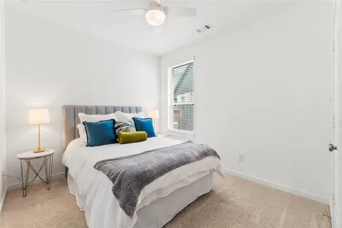 a bedroom with a bed and a night stand