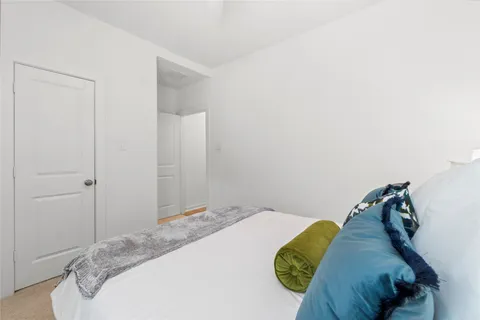 a bedroom with a bed and a painting on the wall