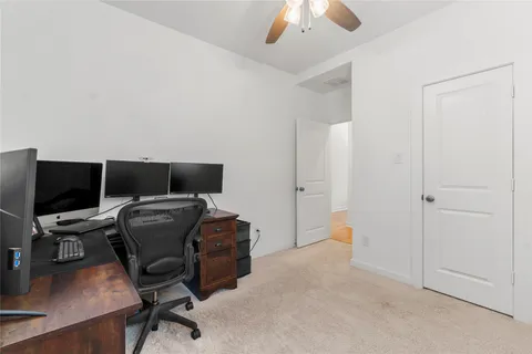 a livingroom with workspace and a window