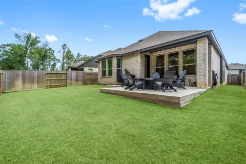 a front view of a house with garden and patio