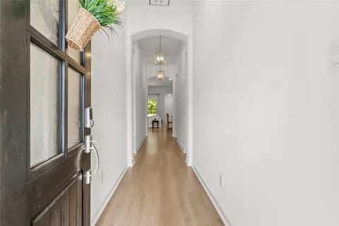 a view of a hallway with wooden floor and stairs