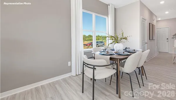 a view of a dining room with furniture and a potted plant