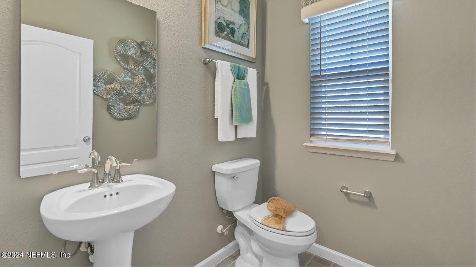 264 Belfort Court St. Augustine, FL 32092 - Photo 15 of 15 a bathroom with a toilet sink and mirror