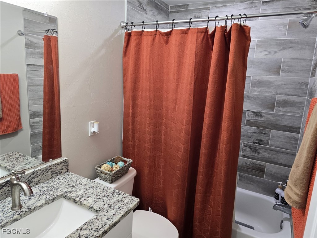 112 Rowland Road Lehigh Acres, FL 33936 - Photo 19 of 31 a bathroom with a sink and a mirror