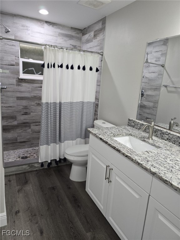 112 Rowland Road Lehigh Acres, FL 33936 - Photo 23 of 31 a bathroom with a granite countertop sink toilet and shower