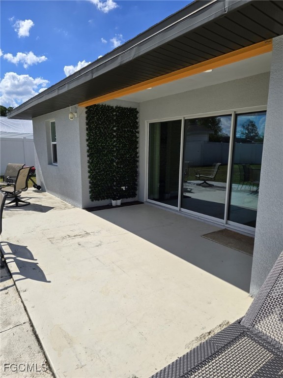112 Rowland Road Lehigh Acres, FL 33936 - Photo 24 of 31 a bedroom with a bed and a large window