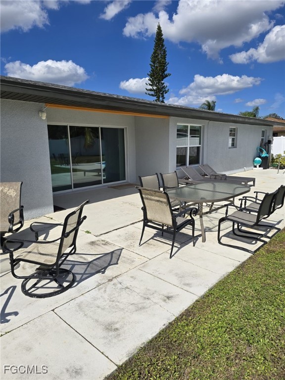 112 Rowland Road Lehigh Acres, FL 33936 - Photo 27 of 31 a view of a patio with table and chairs with wooden floor and fence