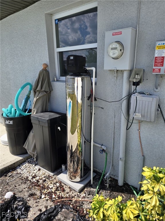 112 Rowland Road Lehigh Acres, FL 33936 - Photo 31 of 31 a room with water heater and wooden floor