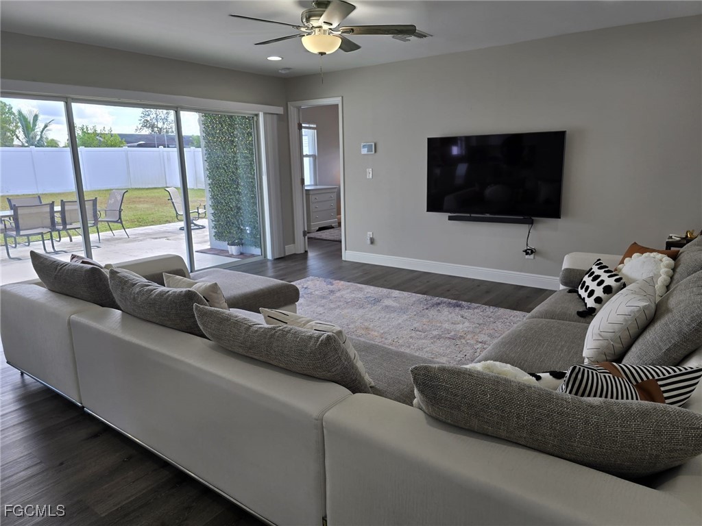 112 Rowland Road Lehigh Acres, FL 33936 - Photo 6 of 31 a living room with furniture and a flat screen tv