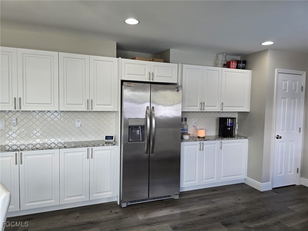 112 Rowland Road Lehigh Acres, FL 33936 - Photo 7 of 31 a kitchen with cabinets and stainless steel appliances